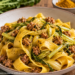 Un piatto fumante di Pappardelle con puntarelle e salsiccia nostrana, arricchite da un pizzico di curry.