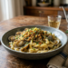 Primo piatto di pasta con vongole e granella di pane nero al sesamo.